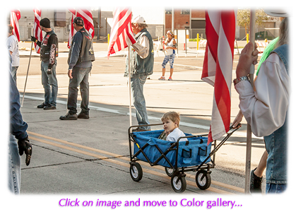 a little boy pulled along in a wagon at the 2015 honor walk in phoenix arizona