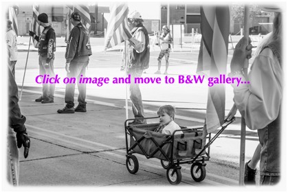 black and white photo of a little boy pulled along in a wagon at the 2015 honor walk in phoenix arizona
